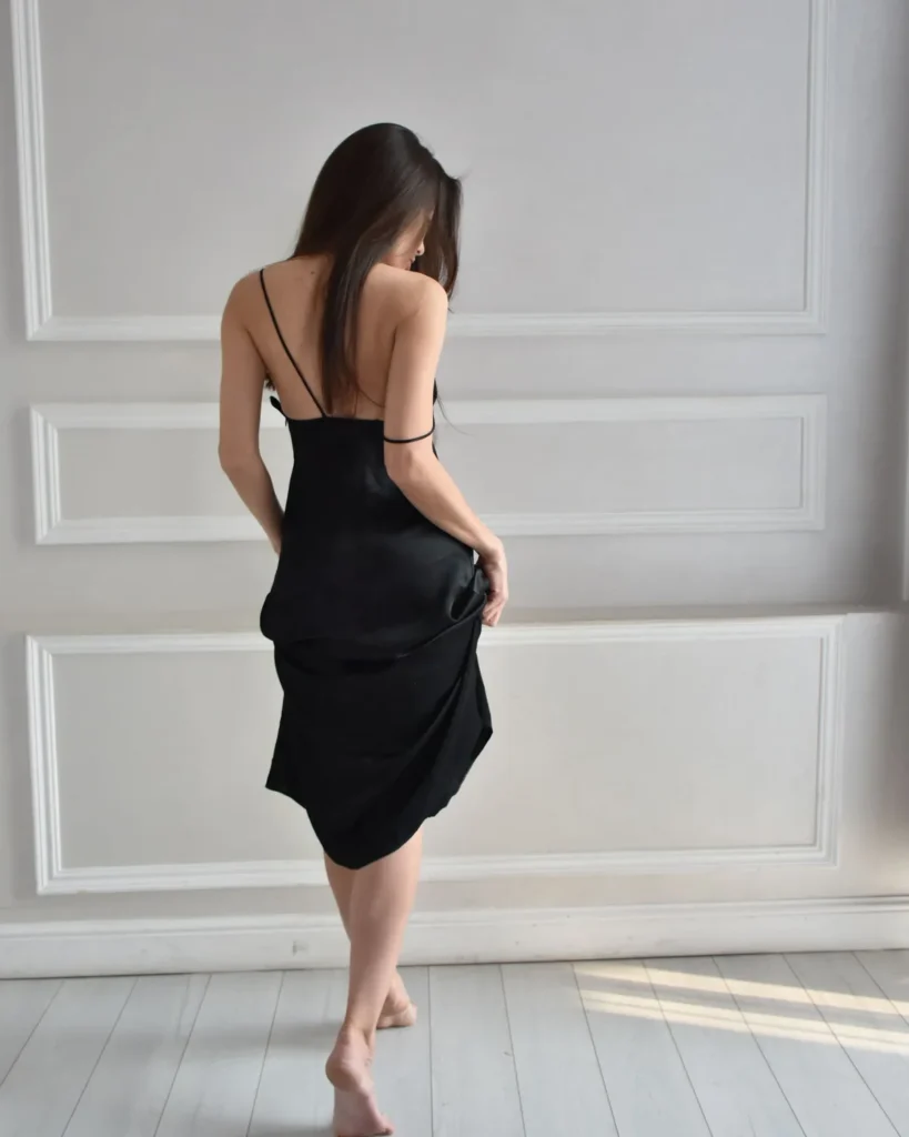 casual dresses under $30 — woman in a simple black midi dress