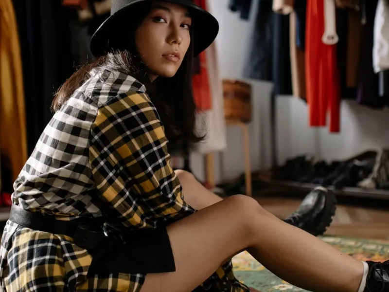 casual dresses under $30 — woman in a plaid shirt dress with boots