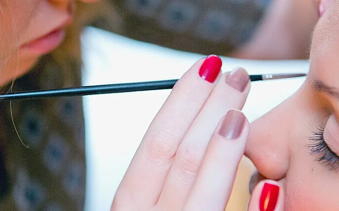 viral beauty dupes under $15 — makeup artist applying makeup