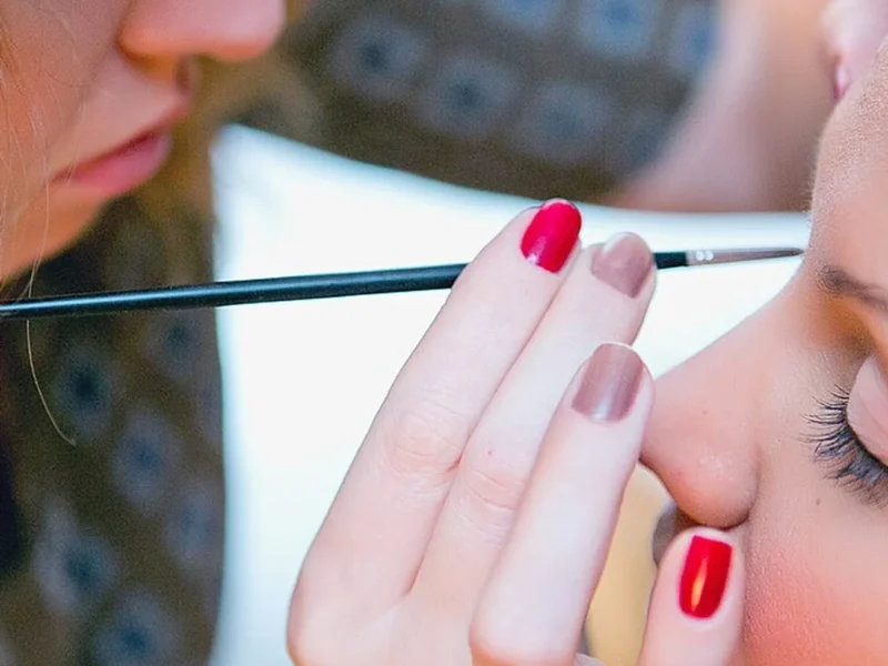 viral beauty dupes under $15 — makeup artist applying makeup
